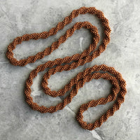 long continuous beaded crochet rope necklace in copper brown