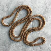 long continuous beaded crochet rope necklace in brown, cream and neutrals