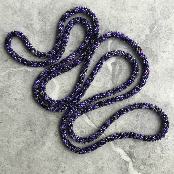 long continuous beaded crochet rope necklace in purple, silver, pink and black