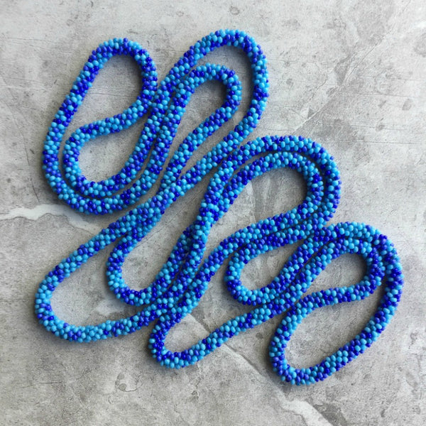long continuous beaded crochet rope necklace in blue
